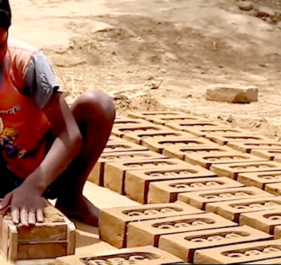 African boy making bricks