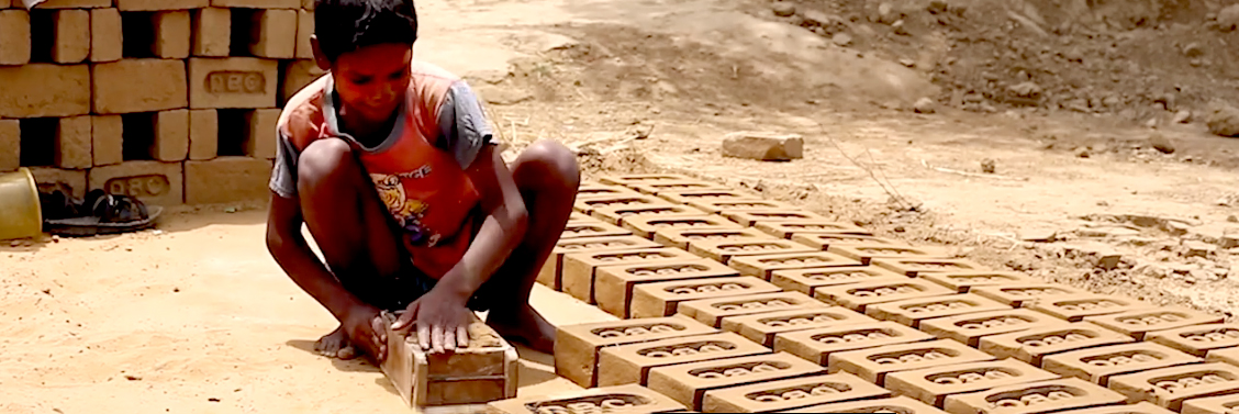 African boy making bricks