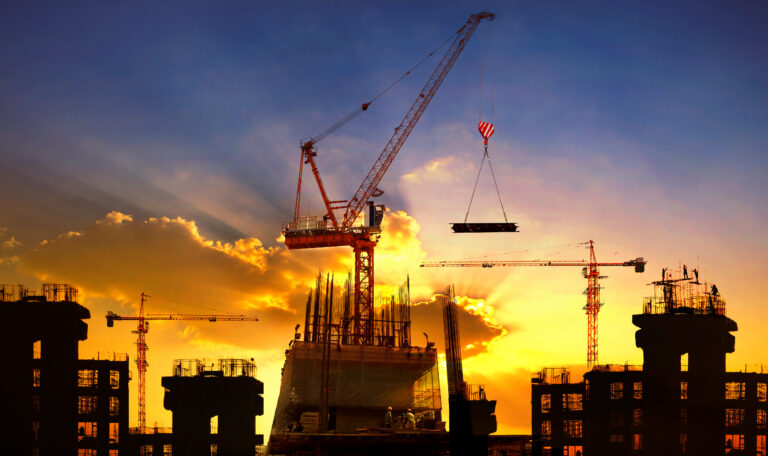 big crane and building construction against beautiful dusky sky use for construction industry and engineering