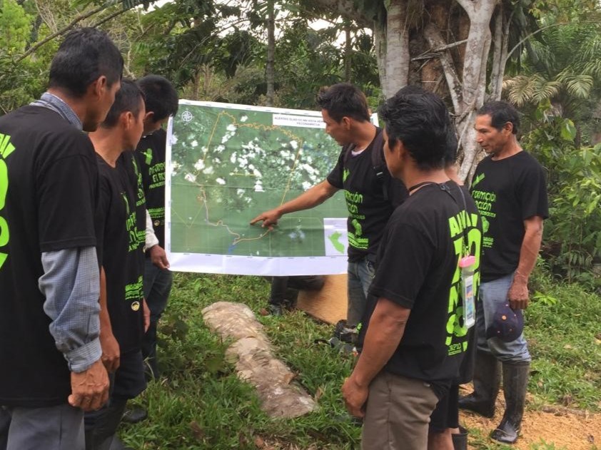 Men in Peru looking at map. 